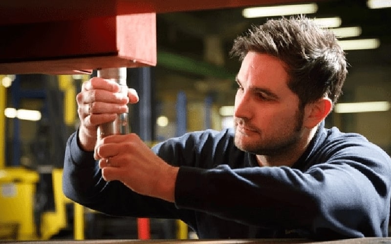 Engineers troubleshooting electrical and gas consoles on a gantry plasma machine